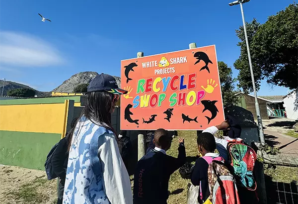Volunteer and Children Outside Swop Shop