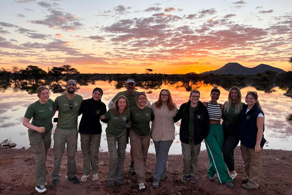 Ryan and volunteers against the sunset