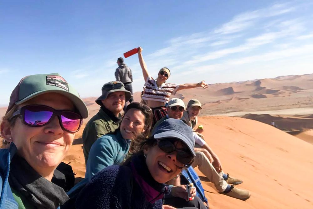 People appropriately dressed on volunteer excursion to sand dunes