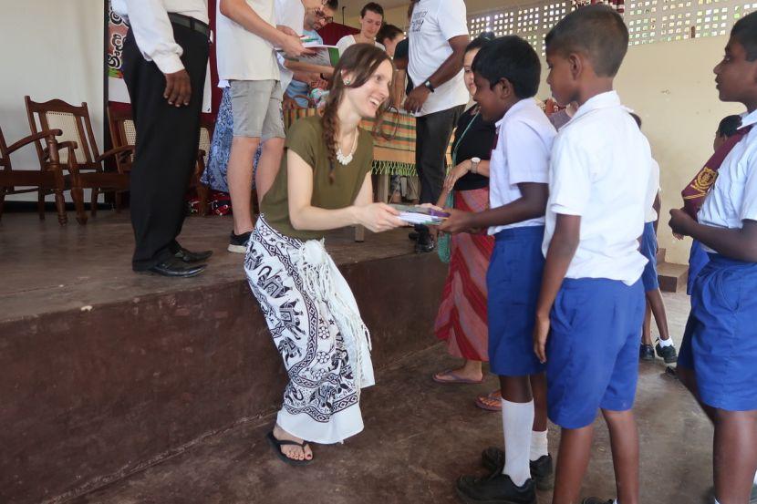 volunteers donating colouring supplies to children in Sri Lanka 