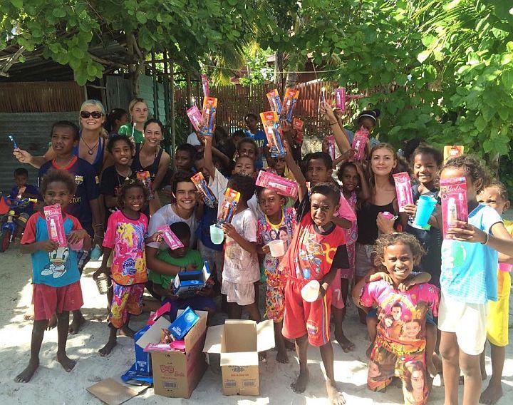 Kids getting toothbrushes on Raja Ampat